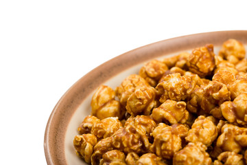 caramel popcorn on a plate macro isolated