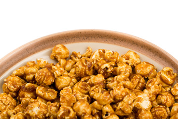 caramel popcorn on a plate macro isolated