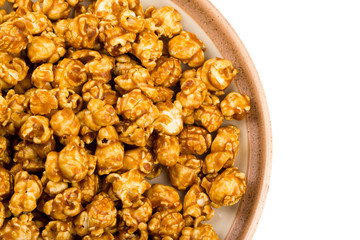 caramel popcorn on a plate macro isolated