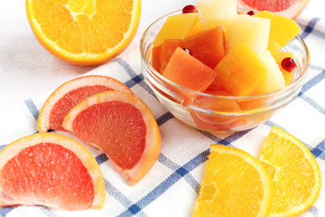 Fototapeta na wymiar Fruit fresh juicy salad with orange, pineapple, grapefruit and pomegranate breakfast for vitamins on a light background