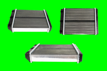 Many engine cooling radiators isolated on green background. Auto spare parts for passenger car. Chromakey