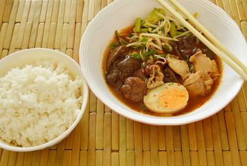 boiled pork entrails topping egg in brown soup eat couple with rice