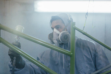Close-up of man in uniform painting bicycle