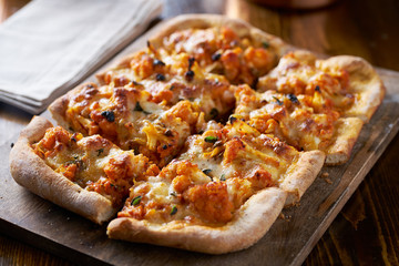 vegetarian cauliflower pizza with melted mozzarella cheese and oregano