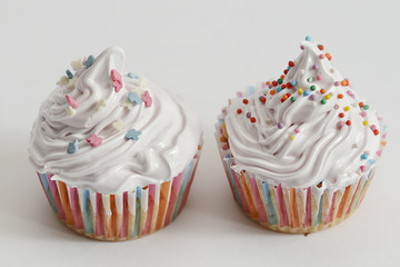 Cupcakes with white cream and sprinkles
