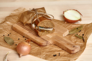 Big sandwich on wooden cutting board with ingridients