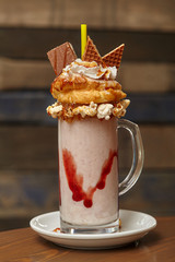 Marshmallow milk shake cocktail with whipped cream, cookies, waffles, treats
