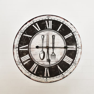 vintage wooden clock on white brick wall
