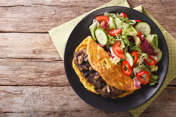 Austrian Imperial Steak with mushrooms, scrambled eggs and fresh salad. horizontal top view