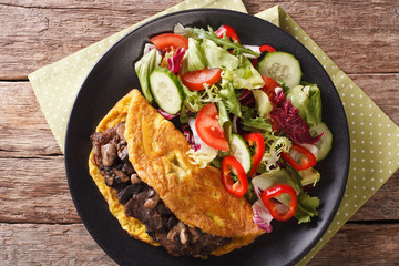 Austrian cutlet with mushrooms, scrambled eggs and vegetable salad. horizontal top view