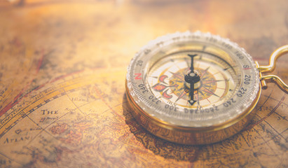 Fototapeta na wymiar Old vintage retro golden compass on ancient map