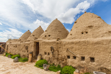 Fototapeta na wymiar Harran, Sanliurfa. Photo of the typical Harran house. Houses is made of mudbrick. Door and small windows can be seen too. Conic shaped and mudbrick and conic roofs are special to Harran area.