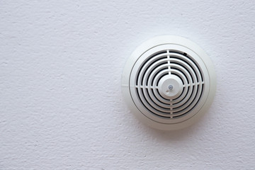 Fototapeta na wymiar Fire alarm smoke detector on celling