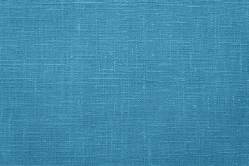 The rough texture of the fabric. Plain weave. Blue canvas. For any design.
