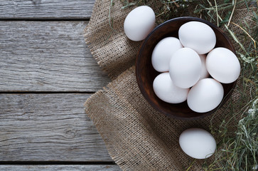 Fresh chicken brown eggs on sack, organic farming background