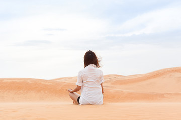 Fototapeta na wymiar Woman In Desert Sitting Lotus Pose Young Girl Meditating