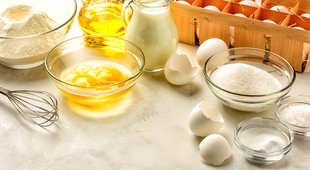 Ingredients for making pancakes on a white background