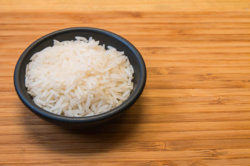 White rice in the black bowl and space in right side