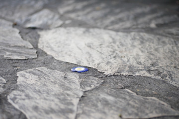 The evil eye bead inside the concrete of rocky road