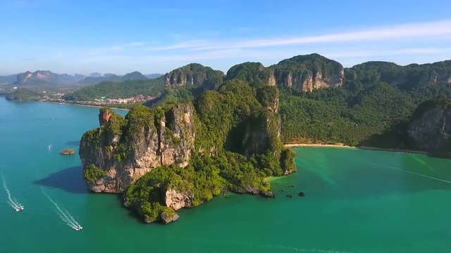 Aerial: Big Mountain with many Long Tail Boats near Railey beach, Krabi, Thailand. HD slowmotion.