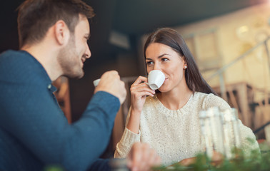 Romantic loving couple drinking coffee, having a date in the cafe. Dating, love, relationships
