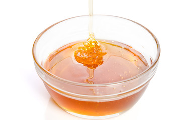 bowl of honey isolated on white background