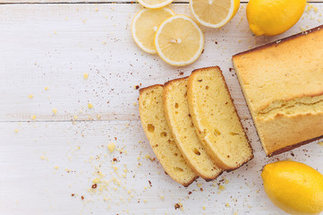 lemon cake with fruits on white wooden surface