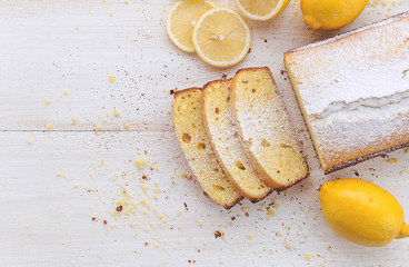 lemon cake with fruits on white wooden surface