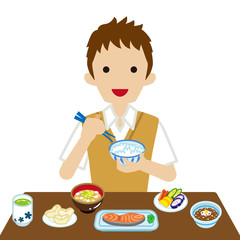 和食の朝食を食べる男子高校生