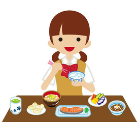 和食の朝食を食べる女子高校生