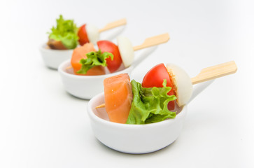 appetizer of salmon, tomatoes and eggs with lettuce leaf