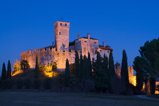 Castle of Villalta with the tower of Fagagna and the Alps in the background during the blue hour after the sunset, Friuli, Italy


