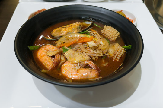 Closeup Jjamppong or Jjampong (Korean spicy seafood noodle soup)