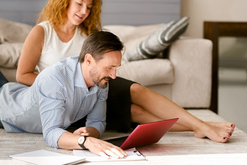 Fototapeta premium Creative aged couple working together at home