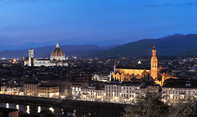 Fototapeta na wymiar Evening sky and lights illuminate medieval buildings and Palazzo Vecchio and Duomo Santa Maria Del Fiore in Florence, Tuscany, Italy
