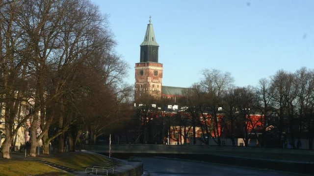 Timelapse of people near aurajoki and turku church, at a evening, in Turku, Varsinais-suomi, Finland