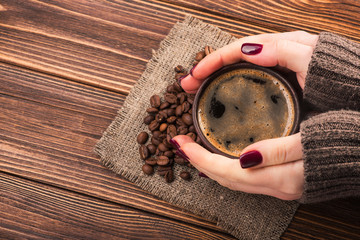 woman holding a hot cup of coffee