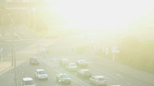 Cars in sunlight. Urban traffic, movement of cars, the road in bright sunlight. Slow motion. 

