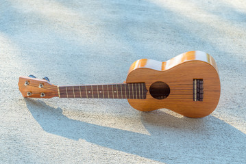 ukulele on a concrete floor