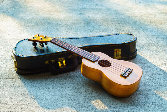 ukulele on a concrete floor