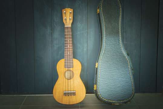 ukulele with black wall background