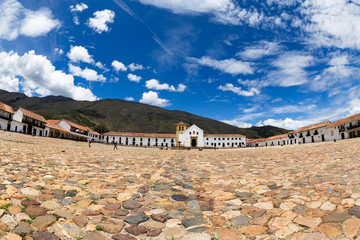 Ultra wide shot of vivid blue sky and white clouds over the central plaza in Villa de Leyva,...