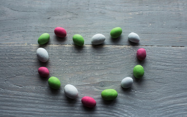 bright candy in heart on wood