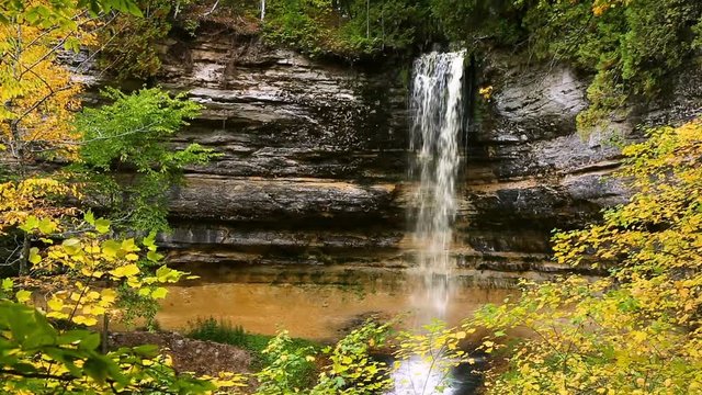Video loop features a waterfall, Munising Falls in Michigan's Pictured Rocks National Lakeshore, slashing down in the midst of colorful autumn leaves. 