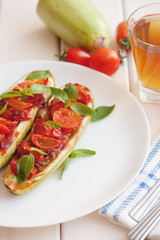 Vegetarian food. Baked zucchini with tomato and basil