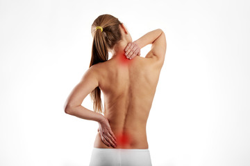 Tired woman massaging back and neck muscles. Health care and medicine. 
