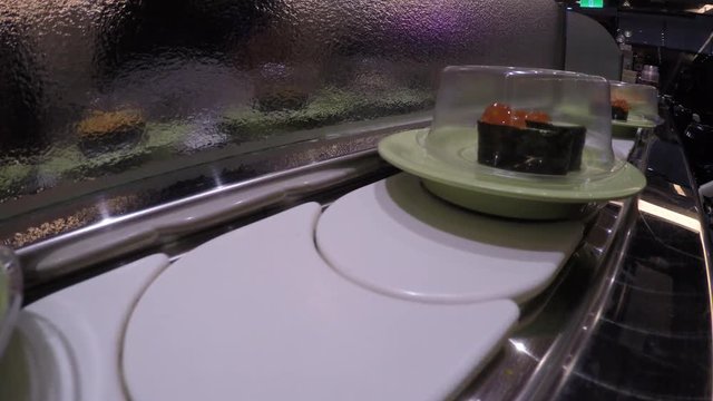 4k, Sushi on conveyor belt in Japan Restaurant, Traditional Japanese food in a restaurant conveyed on a moving belt, Shushi Go Round is a form fast-food common in Asia, also known as sushi train -Dan
