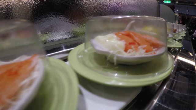 4k, Sushi on conveyor belt in Japan Restaurant, Traditional Japanese food in a restaurant conveyed on a moving belt, Shushi Go Round is a form fast-food common in Asia, also known as sushi train -Dan