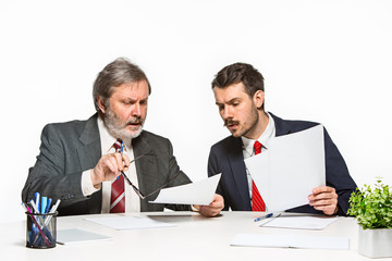 The two colleagues working together at office on white background.