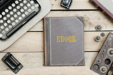 Ebook on old book cover at office desk with vintage items © MichaelJBerlin